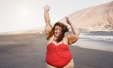 Curvy Overweight Woman Smiling with Beach on