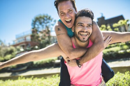 Laughing Man Carrying His Boyfriend Piggyback